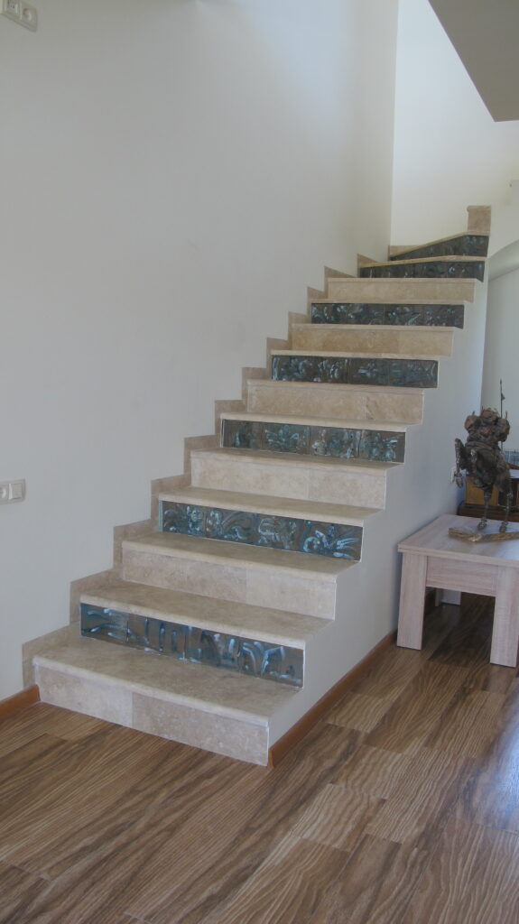 Stairs to the gallery, ceramic tiles and stones